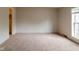 This is a large bedroom with neutral colored walls and carpet, and a closet to the left at 3149 Carson Ave, Indianapolis, IN 46227