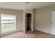 The bedroom is carpeted and has a window and closet at 3149 Carson Ave, Indianapolis, IN 46227