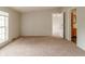This is a carpeted bedroom with one window and an open doorway to a bathroom and another bedroom at 3149 Carson Ave, Indianapolis, IN 46227