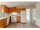 Efficient kitchen featuring white appliances, light countertops, and oak cabinets at 3149 Carson Ave, Indianapolis, IN 46227