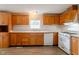 Practical kitchen with white appliances, wooden cabinets, and ample counter space at 3149 Carson Ave, Indianapolis, IN 46227