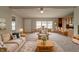 Open-concept living room and dining area featuring plush seating and abundant natural light at 3149 Carson Ave, Indianapolis, IN 46227
