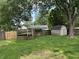 Grassy backyard featuring a wooden deck with stairs and a storage shed, providing space and utility at 3259 Pawnee Dr, Indianapolis, IN 46235