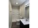 Bathroom featuring a shower, new vanity, modern flooring, and updated fixtures at 3259 Pawnee Dr, Indianapolis, IN 46235