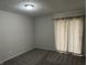 Cozy bedroom featuring carpet flooring, neutral paint, and window with sheer curtains at 3259 Pawnee Dr, Indianapolis, IN 46235