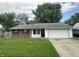 Charming single-story home with brick facade, attached garage, and well-maintained front lawn at 3259 Pawnee Dr, Indianapolis, IN 46235