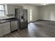 Modern kitchen with stainless steel appliances, gray cabinetry, and view into the dining room at 3259 Pawnee Dr, Indianapolis, IN 46235