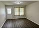 Bright living room featuring modern flooring, neutral paint, window and exterior door at 3259 Pawnee Dr, Indianapolis, IN 46235