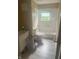 Bathroom featuring a tub with shower, toilet, window, and neutral colors at 3570 Decamp Dr, Indianapolis, IN 46226