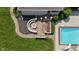 Aerial view of backyard featuring a custom fire pit, patio, manicured lawn, and swimming pool at 3795 Claybrook Ct, Bargersville, IN 46106