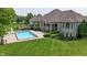 Stunning backyard aerial view with pool, landscaped patio and expansive manicured lawn at 3795 Claybrook Ct, Bargersville, IN 46106