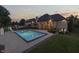 Gorgeous backyard with a luxurious pool, slide, patio, and outdoor fireplace for elegant entertaining at 3795 Claybrook Ct, Bargersville, IN 46106