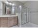 This bathroom features a glass-enclosed shower, wood cabinets, large mirror, and updated fixtures at 3795 Claybrook Ct, Bargersville, IN 46106