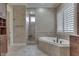 Bright bathroom featuring a soaking tub, tiled shower and custom vanity, complete with natural light at 3795 Claybrook Ct, Bargersville, IN 46106