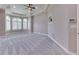 A second view of the spacious primary bedroom with neutral carpet, trim, ceiling fan, and great light at 3795 Claybrook Ct, Bargersville, IN 46106