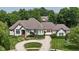 Elegant exterior with stone accents, manicured landscaping, and a circular driveway leading to a three car garage at 3795 Claybrook Ct, Bargersville, IN 46106