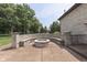 Inviting outdoor patio features a custom stone fire pit with built-in seating and mature trees at 3795 Claybrook Ct, Bargersville, IN 46106