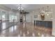 Bright foyer boasts hardwood floors, a chandelier, and a view of the backyard through large windows at 3795 Claybrook Ct, Bargersville, IN 46106