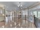 Spacious foyer featuring hardwood floors, neutral paint, elegant chandelier, and staircase with wrought iron railing at 3795 Claybrook Ct, Bargersville, IN 46106