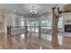 Open foyer with hardwood floors, a fireplace, staircase with iron railing, and many windows at 3795 Claybrook Ct, Bargersville, IN 46106