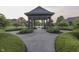 Well-manicured landscaping and circular driveway featuring a gazebo at 3795 Claybrook Ct, Bargersville, IN 46106