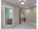 Hallway with a bathroom and a glimpse of the lower level featuring an elegant light fixture at 3795 Claybrook Ct, Bargersville, IN 46106