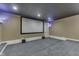 Finished basement home theater with projector screen and neutral carpet at 3795 Claybrook Ct, Bargersville, IN 46106