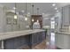 Well-lit kitchen with granite island, pendant lights, and hardwood floors at 3795 Claybrook Ct, Bargersville, IN 46106