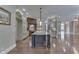 Well-equipped kitchen with island with a stone countertop, pendant lighting and hardwood floors at 3795 Claybrook Ct, Bargersville, IN 46106