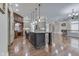 Well-equipped kitchen boasts an island with a stone countertop, pendant lights, and hardwood floors at 3795 Claybrook Ct, Bargersville, IN 46106