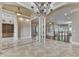Spacious living area featuring decorative tile flooring, ornate columns and elegant chandelier at 3795 Claybrook Ct, Bargersville, IN 46106