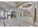 Spacious living area featuring decorative tile flooring, ornate columns and elegant chandelier at 3795 Claybrook Ct, Bargersville, IN 46106