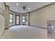 Spacious living room featuring neutral carpet, a ceiling fan, and large windows for natural light at 3795 Claybrook Ct, Bargersville, IN 46106