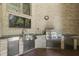 Outdoor kitchen featuring stainless steel appliances, brick surround, sink, and mounted television at 3795 Claybrook Ct, Bargersville, IN 46106