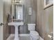 Stylish powder room with decorative walls, pedestal sink, and elegant fixtures at 3795 Claybrook Ct, Bargersville, IN 46106