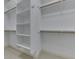 Walk-in closet featuring white shelving and wooden rods for optimized storage and organization at 3795 Claybrook Ct, Bargersville, IN 46106