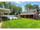 The backyard is meticulously kept with a in ground pool, a barn, and luscious greenery at 3905 E 550 S, Lebanon, IN 46052