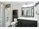 Bathroom featuring a tiled shower, stylish vanity, and dark framed mirror at 3905 E 550 S, Lebanon, IN 46052