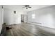 Bedroom with gray wood floors, a window, and two entryways to other parts of the house at 3905 E 550 S, Lebanon, IN 46052