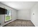 Neutral bedroom featuring plush carpet, a bright window, and a wall-mounted TV at 3905 E 550 S, Lebanon, IN 46052