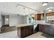 Kitchen with stainless steel appliances, tile backsplash, and island with granite countertops overlooking the living room at 3905 E 550 S, Lebanon, IN 46052
