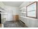Functional laundry room with ample shelving, a utility sink, a door to the outside, and a window at 3905 E 550 S, Lebanon, IN 46052