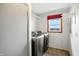 Bright laundry room with modern washer and dryer, and window with red valance for natural light at 3905 E 550 S, Lebanon, IN 46052