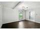 An empty living room with hardwood floors, modern light fixture, and natural light coming in through the window at 3905 E 550 S, Lebanon, IN 46052