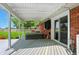Back patio featuring a hot tub with wooden deck and view of the yard at 3905 E 550 S, Lebanon, IN 46052