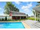 A large pool with a nearby deck overlooks a barn in a well maintained yard at 3905 E 550 S, Lebanon, IN 46052