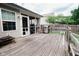 Wooden deck with grill, screened porch, and a view of the grassy backyard and fence at 4233 Pearson Dr, Westfield, IN 46062