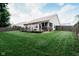 Exterior view of home featuring a spacious backyard with deck, patio furniture, and lawn at 4233 Pearson Dr, Westfield, IN 46062