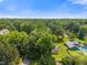 Aerial view of wooded area with private home featuring a pool and lush backyard at 4350 Sylvan Rd, Indianapolis, IN 46228
