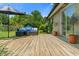 Wooden deck featuring an outdoor seating area with a sofa, umbrella, playset and green lawn at 4350 Sylvan Rd, Indianapolis, IN 46228